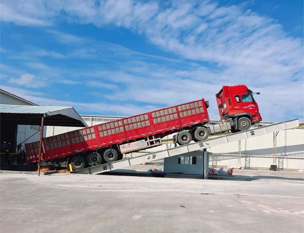 液壓卸車機、后翻式液壓翻板卸車平臺、河南愛信液壓翻板機